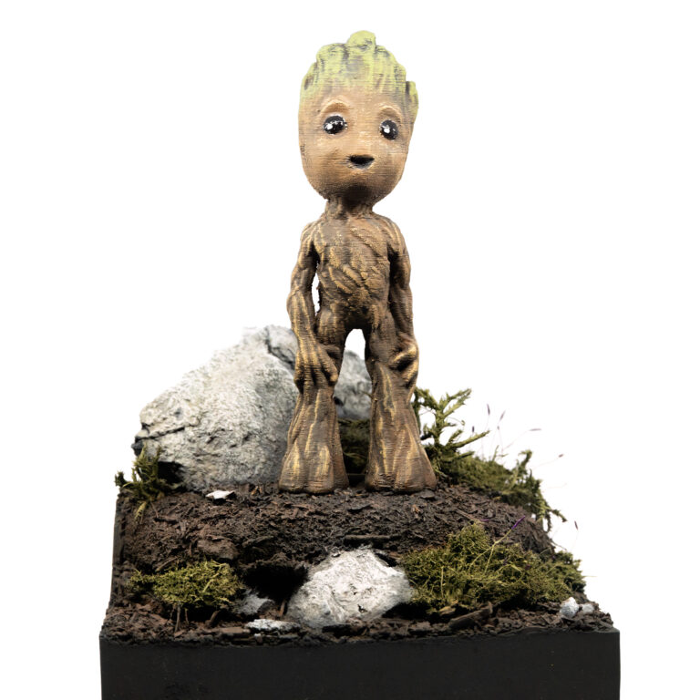 Bemalte 3D-Druck-Figur von Baby Groot frontal auf einem Erddiorama, Marvel