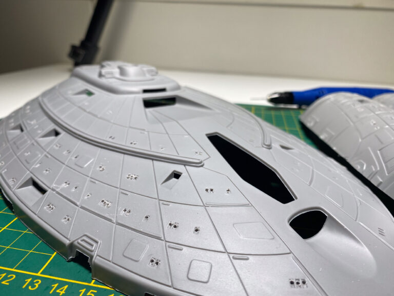 Grundierte Untertasse des Revell-Modells der USS Voyager im Maßstab 1/670 auf Schneidematte