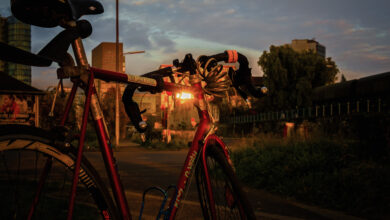 Red road bike against the light at the Düsseldorf harbour, office buildings in the background
